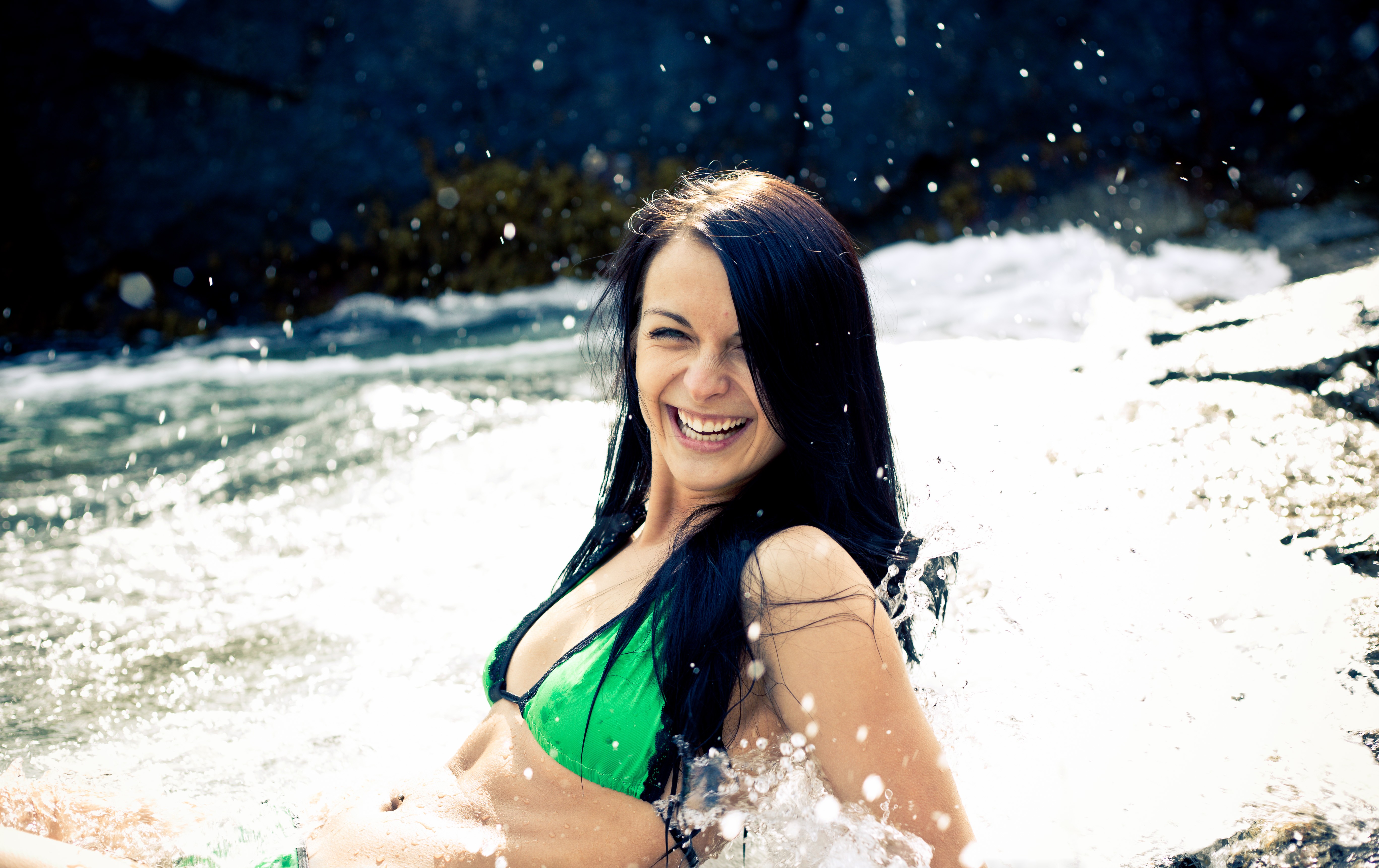 Joyful coastal swimsuit portrait in moving water
